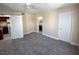 Bedroom with carpeted floors, neutral walls, ceiling fan, and access to the kitchen and bathroom at 6800 E Lake Mead Blvd # 2024, Las Vegas, NV 89156