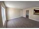 Well-lit living room with neutral walls and new carpeting offers seamless transition to kitchen and other rooms at 6800 E Lake Mead Blvd # 2024, Las Vegas, NV 89156