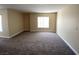 Spacious living room featuring neutral paint, clean carpeting, and bright windows with natural light at 6800 E Lake Mead Blvd # 2024, Las Vegas, NV 89156