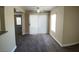 Bright living room with neutral walls and new carpeting leads to sliding door with blinds and ceiling fan at 6800 E Lake Mead Blvd # 2024, Las Vegas, NV 89156