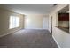 Bright living room with neutral walls and new carpeting offers seamless transition to kitchen and other rooms at 6800 E Lake Mead Blvd # 2024, Las Vegas, NV 89156