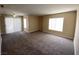 Bright living room with neutral walls, new carpeting, and large window and sliding door providing natural light at 6800 E Lake Mead Blvd # 2024, Las Vegas, NV 89156
