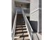 Exterior staircase leads to a condo entrance with white railings and textured stucco walls at 6800 E Lake Mead Blvd # 2024, Las Vegas, NV 89156