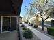 View from the covered balcony highlighting access to an outdoor walkway and common area landscaping with mature trees at 6868 Sky Pointe Dr # 1118, Las Vegas, NV 89131