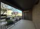 Enjoy outdoor living on this cozy balcony with black railings, offering a serene view of the community courtyard at 6868 Sky Pointe Dr # 1118, Las Vegas, NV 89131