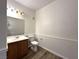 Cozy bathroom with a wood vanity, updated lighting and a toilet at 6868 Sky Pointe Dr # 1118, Las Vegas, NV 89131
