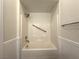 Clean bathroom featuring a tub-shower combo with white tile surround, grab bar and modern hardware at 6868 Sky Pointe Dr # 1118, Las Vegas, NV 89131