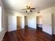 Spacious bedroom featuring wood floors, a ceiling fan, and multiple closets with ample storage at 6868 Sky Pointe Dr # 1118, Las Vegas, NV 89131