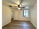 Cozy bedroom with wood-look floors, ceiling fan, and ample natural light from a large window at 6868 Sky Pointe Dr # 1118, Las Vegas, NV 89131