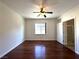 Large bedroom with wooden floors, a ceiling fan, a view from the window, and an ensuite bathroom at 6868 Sky Pointe Dr # 1118, Las Vegas, NV 89131