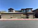 Attractive condo complex with private garages and stacked stone accents under a clear blue sky at 6868 Sky Pointe Dr # 1118, Las Vegas, NV 89131