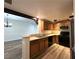 Efficient kitchen featuring stainless appliances, wood cabinets, and breakfast bar at 6868 Sky Pointe Dr # 1118, Las Vegas, NV 89131