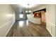 Open living space featuring wood-look floors, view of the kitchen, and access to the balcony at 6868 Sky Pointe Dr # 1118, Las Vegas, NV 89131