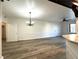 Spacious living area with wood-look floors, chandelier, and views of the entry at 6868 Sky Pointe Dr # 1118, Las Vegas, NV 89131