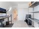 Versatile space with a desk, storage racks, and ample room, suitable for a home office or hobby area at 7132 Sayonara Vista St, North Las Vegas, NV 89084