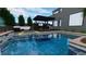 Luxury pool area with covered patio and outdoor seating at 7132 Sayonara Vista St, North Las Vegas, NV 89084