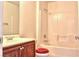 Bathroom featuring a single sink, mirror, and a shower with a red toilet seat at 72 Broken Putter Way, Las Vegas, NV 89148