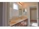 Bright bathroom featuring dual sinks, mirrors, and access to bedroom at 72 Broken Putter Way, Las Vegas, NV 89148