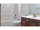 Bathroom with a tiled tub, neutral wall, and dark vanity with sink at 72 Broken Putter Way, Las Vegas, NV 89148