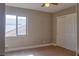 Bedroom with neutral carpet, a window, and closet space at 72 Broken Putter Way, Las Vegas, NV 89148