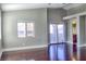Large bedroom featuring a window, hardwood floors, and a sliding glass door for outdoor access at 72 Broken Putter Way, Las Vegas, NV 89148