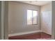 Cozy bedroom showcasing a window with blinds, hardwood floors, and a double door closet at 72 Broken Putter Way, Las Vegas, NV 89148