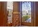 Inviting entryway featuring a decorative iron gate and stone accents, welcoming guests into this beautiful home at 72 Broken Putter Way, Las Vegas, NV 89148