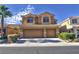 Two-story home featuring a two-car garage, desert landscaping and a tile roof at 72 Broken Putter Way, Las Vegas, NV 89148
