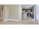 Open-concept kitchen with stainless steel appliances, dark cabinetry, and a breakfast bar for casual dining at 72 Broken Putter Way, Las Vegas, NV 89148