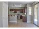 Modern kitchen with stainless steel appliances, dark wood cabinets, and plenty of counter space for cooking at 72 Broken Putter Way, Las Vegas, NV 89148