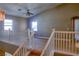 Bright loft with vaulted ceiling and a ceiling fan, as seen from the top of the staircase at 72 Broken Putter Way, Las Vegas, NV 89148