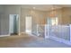 A view of the bright upstairs loft with carpeted floors as seen from the staircase at 72 Broken Putter Way, Las Vegas, NV 89148