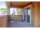 Covered patio with stucco walls and sliding door, offering outdoor living space at 72 Broken Putter Way, Las Vegas, NV 89148