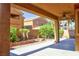 Covered patio features ceiling fan and beautiful landscaping creating a relaxing outdoor space at 72 Broken Putter Way, Las Vegas, NV 89148