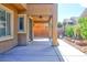 Back patio with cover, garden and walkway with block wall at 72 Broken Putter Way, Las Vegas, NV 89148