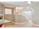 Bright living room view of the staircase with white railing and a view of the granite breakfast bar at 72 Broken Putter Way, Las Vegas, NV 89148