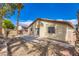 View of the backyard with a concrete patio and stucco walls for privacy at 7547 Rolling River Dr, Las Vegas, NV 89131