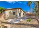 Backyard showcasing a concrete patio extending from the house with desert landscaping at 7547 Rolling River Dr, Las Vegas, NV 89131