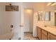 Bathroom with white cabinets, double sinks, shower and tub combo at 7547 Rolling River Dr, Las Vegas, NV 89131