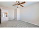 Bright bedroom featuring neutral walls, gray carpet, and a ceiling fan with light fixture at 7547 Rolling River Dr, Las Vegas, NV 89131