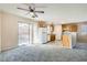 Open floor plan featuring the kitchen with wood cabinets, white appliances, and gray carpet at 7547 Rolling River Dr, Las Vegas, NV 89131