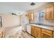 Bright kitchen featuring wood cabinets, white appliances, and a sunny window above the sink at 7547 Rolling River Dr, Las Vegas, NV 89131