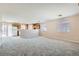 Spacious living room with new carpet flooring and an open layout towards the kitchen area at 7547 Rolling River Dr, Las Vegas, NV 89131