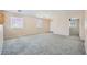 Expansive living room with plush carpeting, neutral walls, and natural light streaming in at 7547 Rolling River Dr, Las Vegas, NV 89131