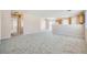 Large open-concept living room boasting modern carpet and views of the kitchen and backyard at 7547 Rolling River Dr, Las Vegas, NV 89131