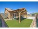 Cozy backyard featuring a charming pergola, artificial grass, and a well-maintained privacy fence at 7825 White Grass Ave, Las Vegas, NV 89131