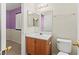 Bathroom featuring a vanity with sink, a mirror and view into the bedroom at 7825 White Grass Ave, Las Vegas, NV 89131