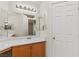Bathroom featuring a single sink, wood cabinets, a makeup vanity, and a door to a closet at 7825 White Grass Ave, Las Vegas, NV 89131