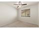 Empty bedroom featuring neutral walls, carpet floors, and a ceiling fan at 7825 White Grass Ave, Las Vegas, NV 89131