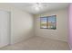 Bright bedroom featuring neutral walls and a window with blinds at 7825 White Grass Ave, Las Vegas, NV 89131